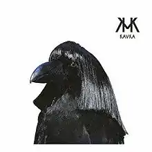 A black crow wearing a human wig.