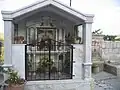 Roadside shrine showing the words "Falem O Mëri" meaning "Hail Mary" in Albanian