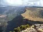 A mountain escarpment with sparse vegetation