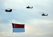 Two of 120 Sqn's AH-64D Apaches escorting a 127 Sqn's CH-47SD Chinook helicopter during the rehearsal for NDP 2006.