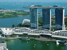 Three buildings connected to each other stand near the seashore