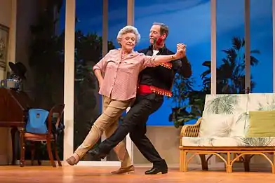 Todd McKenney (red rose in mouth) and Nancye Hayes while dancing the tango in a performance of the play Six Dance Lessons in Six Weeks