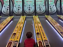 Child playing skee-ball.