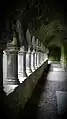 A dark barrel-vaulted corridor with an arcade on the left