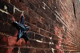 Stars are a common architectural motif from the era of Soulard's building, an anchor plate on brick.