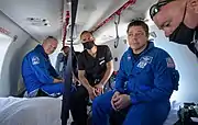 Robert Behnken prepare to depart their helicopter at Naval Air Station Pensacola