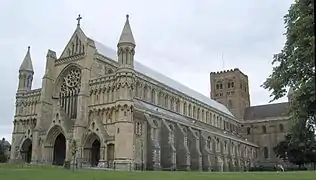 A stone building similar to the church, seen from the same angle, but larger and more ornate