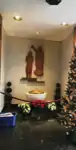 Baptismal font with the depiction of Jesus being baptized by John the Baptist in the background