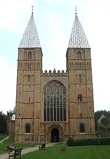 Southwell Cathedral, England, 1120, follows the Norman model with pyramidal spires as were probably at Saint-Étienne. The Perpendicular window and battlement are late Gothic.