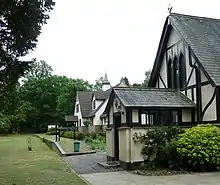 Gabled building with a railway platform behind it.