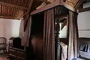 Four-poster bed and cot (left)