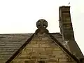 Stone chancel roof cross now on porch gable