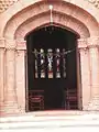 Stained glass in the apse as seen through door in facade