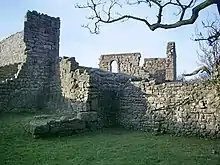 Ruined stone walls with one intact window frame.