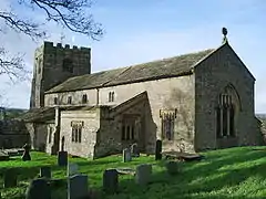 A plain stone church with a clerestory and a west tower.