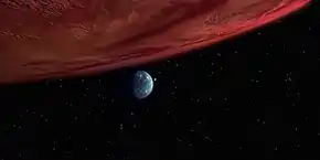 Red gas giant planet and distant small green moon