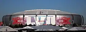 photo of State Farm Stadium taken from the parking lot, showing the domed stadium against an overcast sky