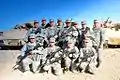 California State Military Reserve troops armed with M16s with 3 Bradleys behind them took a photo while undergo Base Security Training.