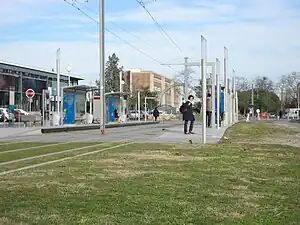 Double-track railway line in grass with shelters on side platforms