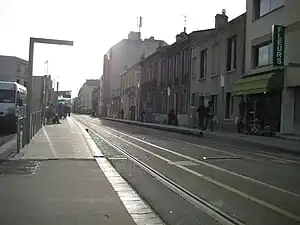 Double-track railway line in the street with side platforms