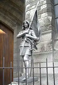 Joan of Arc statue in front of Basilique Sainte-Jeanne-d'Arc in Paris.