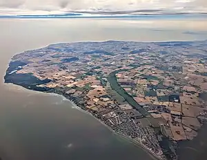 Aerial view of Strøby Egede (lover right) through Køge Sønakke (leftmost tip), looking southeast across Køge Bay