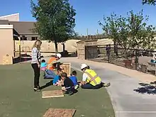 Students hammering nails into wood.