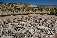 Foundations of former circular buildings.