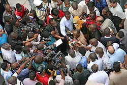 Image 14Photo and broadcast journalists interviewing government official after a building collapse (from Broadcast journalism)