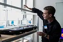 An individual at a workshop station during a Summer School Fluid Dynamics of Sustainability and the Environment session