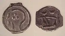 Two coins from the Sunbury hoard, with design derived from Greek coins of Marseilles, with stylised head of Apollo and butting bull, 100–50 BC