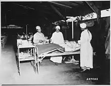 Surgical ward treatment at the 268th Station Hospital in 1944 with Prudence Burns on the left, standing next to Elcena Towncent and an unidentified nurse.