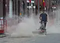 A cleaner using a mechanical sweeper to clean the street