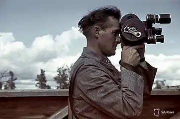 A TK man filming aircraft surveillance Lottas.