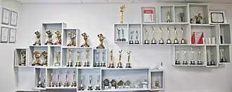 Awards on shelves on a wall