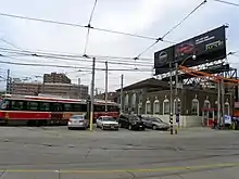 large building with transport vehicles on rails entering and exiting