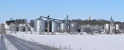 Tarnov seen from the east.  In the foreground are grain bins along the Nebraska Central Railroad track; on the hill right of center is the steeple of St. Michael's Catholic Church, February 2010