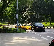 A Center Drive intersection with four cars stopped at a cross road