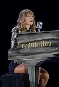 Swift performing on a grand piano