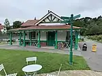 The pavilion; a green and white coloured building, with a brick-red tiled roof