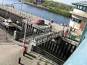 Bascule lifting bridge over the waters of the entrance to the barrage lock.