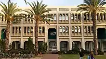 A traditional Israeli architecture building with palm trees in front