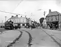 The route 16 tram (left) & the route 15 tram (centre) at Terenure Cross, c. 1900. The line in the foreground connected with the D&BST's Terenure depot. It was used at night to transfer goods between the two systems.