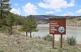 A view of the reservoir and the wildlife area sign