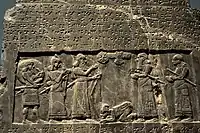 The Black Obelisk of Shalmaneser III. The king, surrounded by his royal attendants and a high-ranking official, receives a tribute from Sua, king of Gilzanu (north-west Iran), who bows and prostrates before the king. From Nimrud