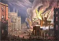 View of the front of the Palace of Westminster on fire, seen from Abingdon Street. Crowds—seen at the bottom of the image—are being held back by soldiers, while firemen can be seen tackling the blaze