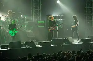 The Cure performing in August 2007; from left to right: Jason Cooper (on drums), Porl Thompson, Robert Smith, and Simon Gallup