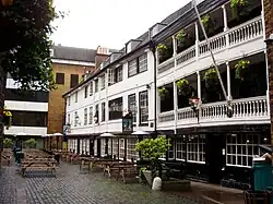 An old pub with galleries with white-painted balustrades.