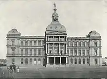 A stately three-storey building with a tower on top