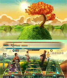 Two virtual color images. The top shows a single leafy tree on an exaggerated hillside, individual curly blades of grass cover it, against a distant image of hills and mountains along with a yellow-orange tinted sunny sky. The bottom image shows elements of the top image incorporated with the Rock Band gameplay elements overlaying it